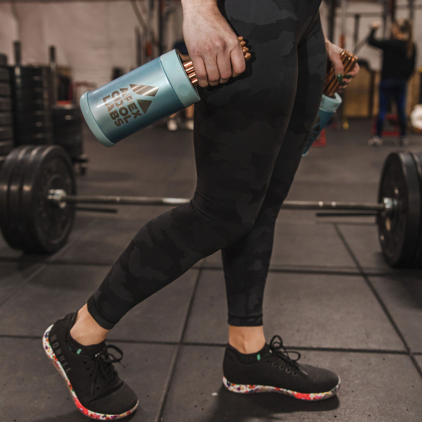 Woman holding a palm cooling device in gym